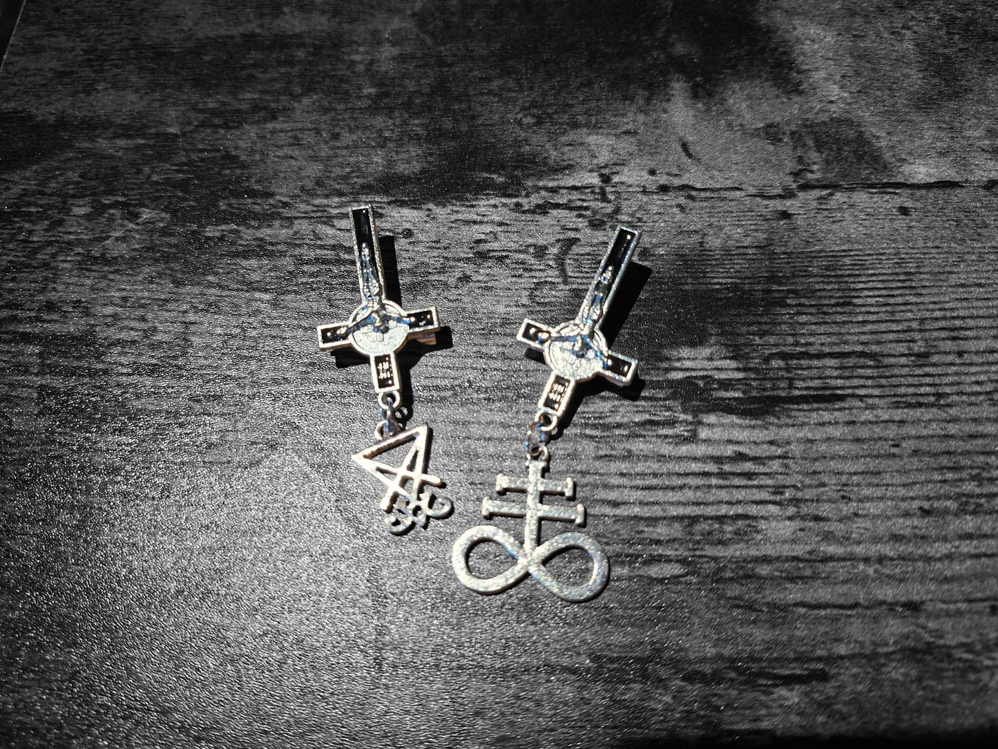 Inverted metal crucifix pin badge with satanic sigils