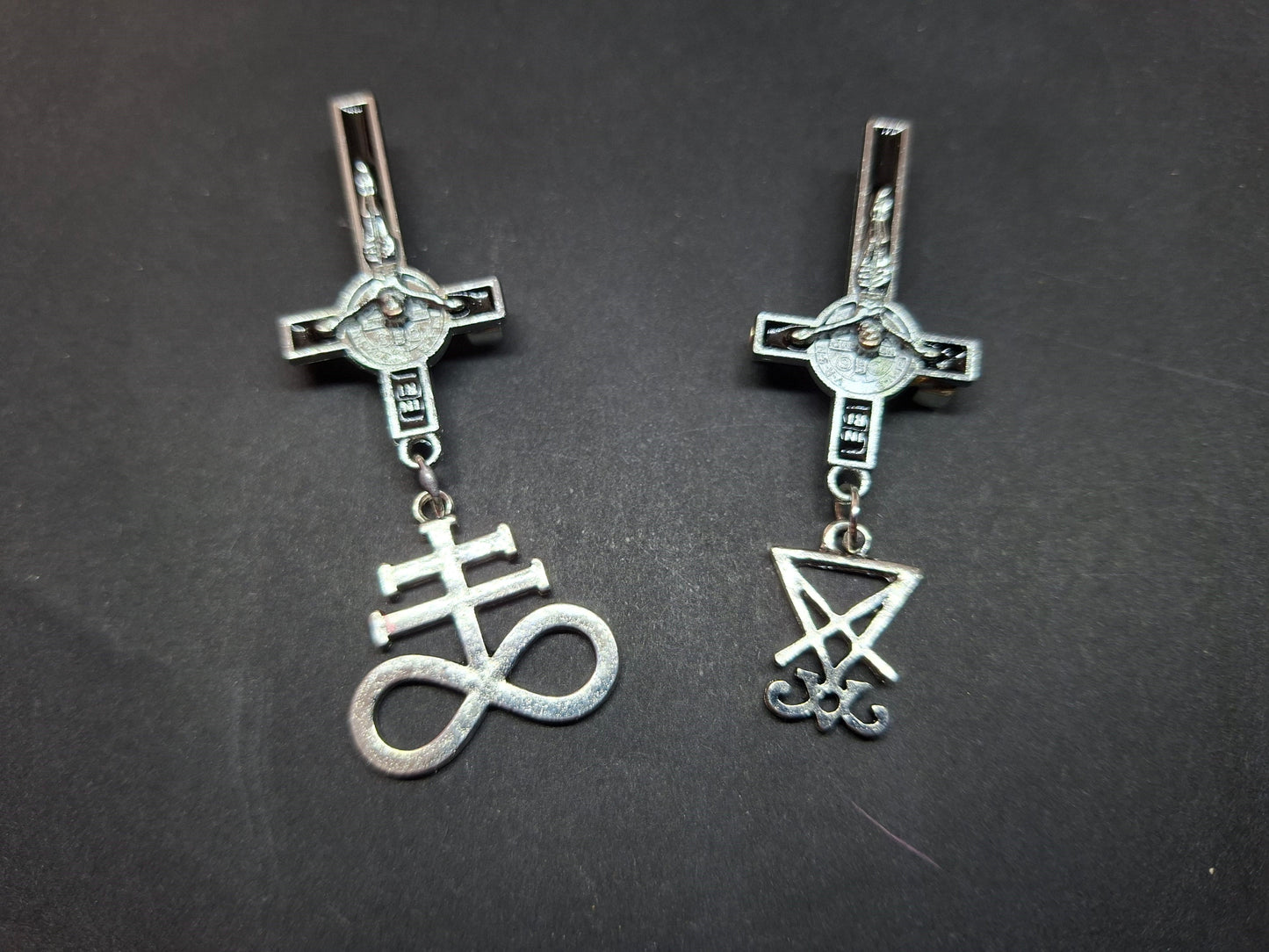 Inverted metal crucifix pin badge with satanic sigils