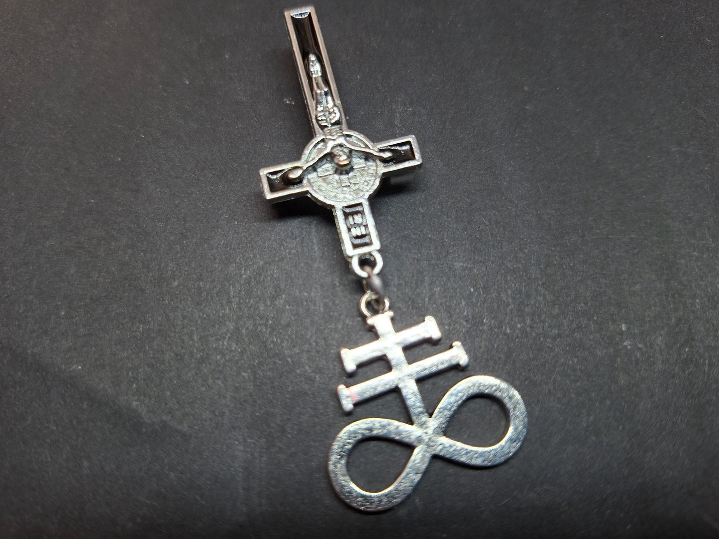 Inverted metal crucifix pin badge with satanic sigils