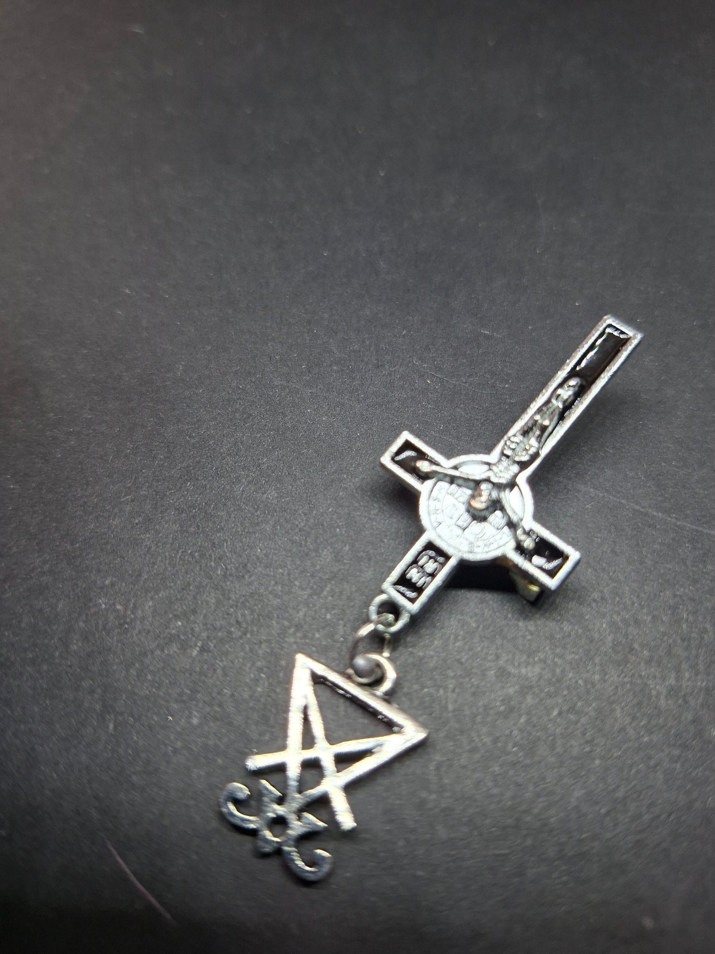 Inverted metal crucifix pin badge with satanic sigils