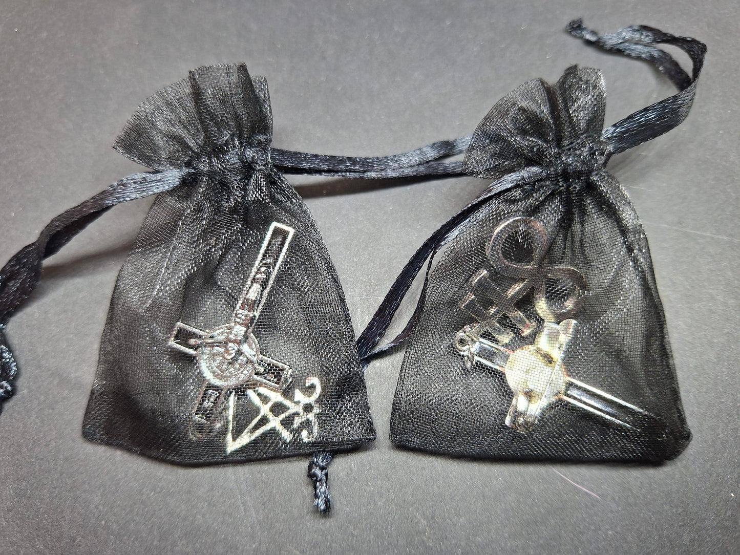 Inverted metal crucifix pin badge with satanic sigils