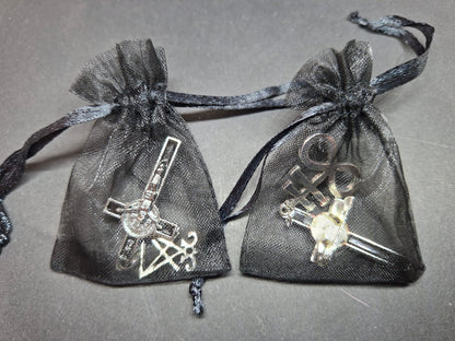 Inverted metal crucifix pin badge with satanic sigils