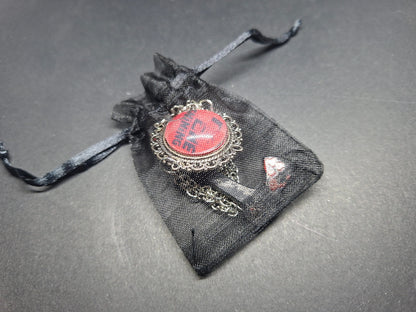 Ornate brooch with chains and blooded axe ,The shining inspired