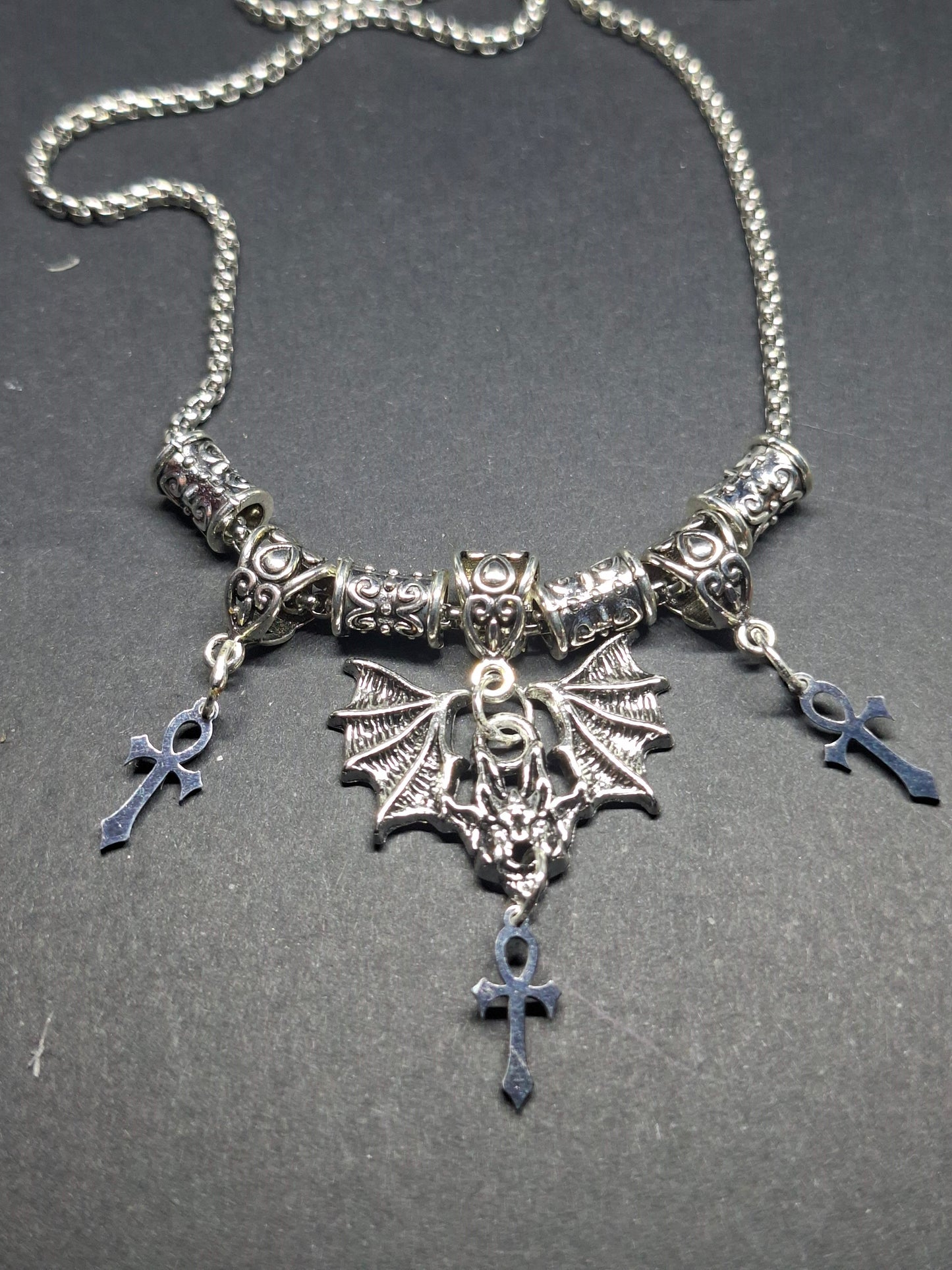 Metal Necklace with bat charm and "Vampire Masquerade ankhs"