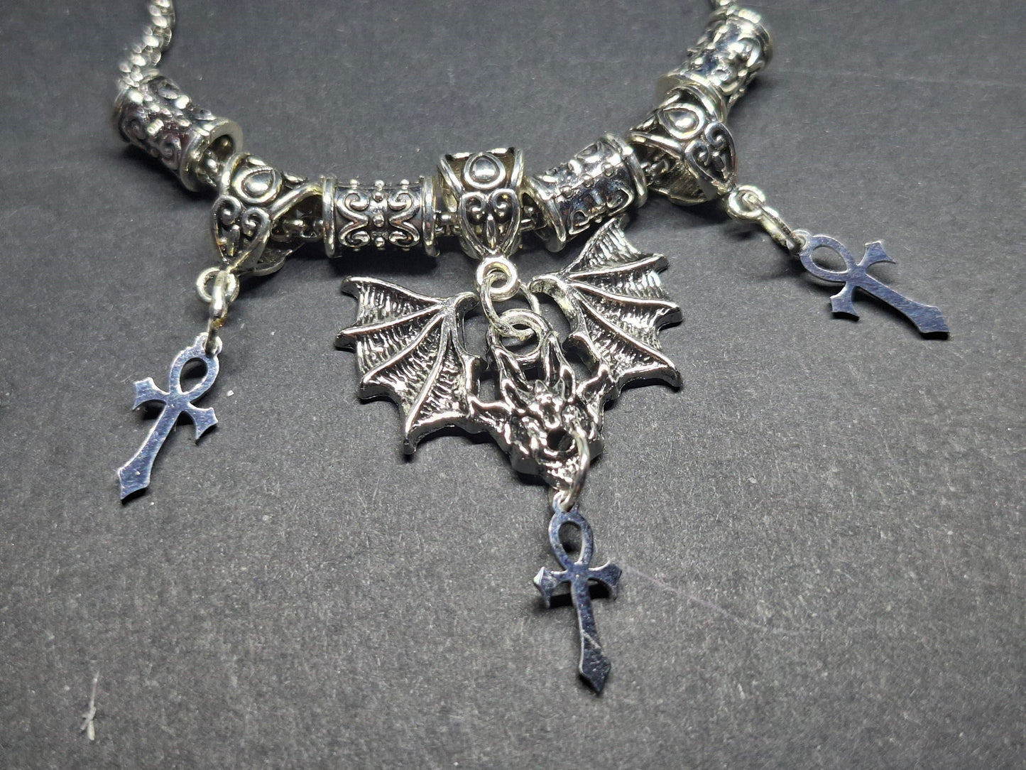 Metal Necklace with bat charm and "Vampire Masquerade ankhs"