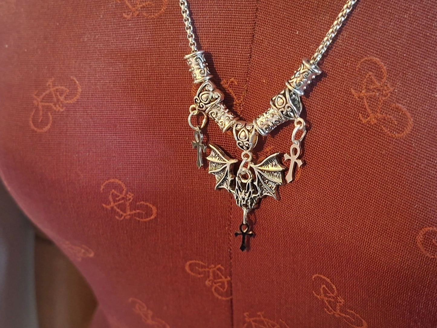 Metal Necklace with bat charm and "Vampire Masquerade ankhs"